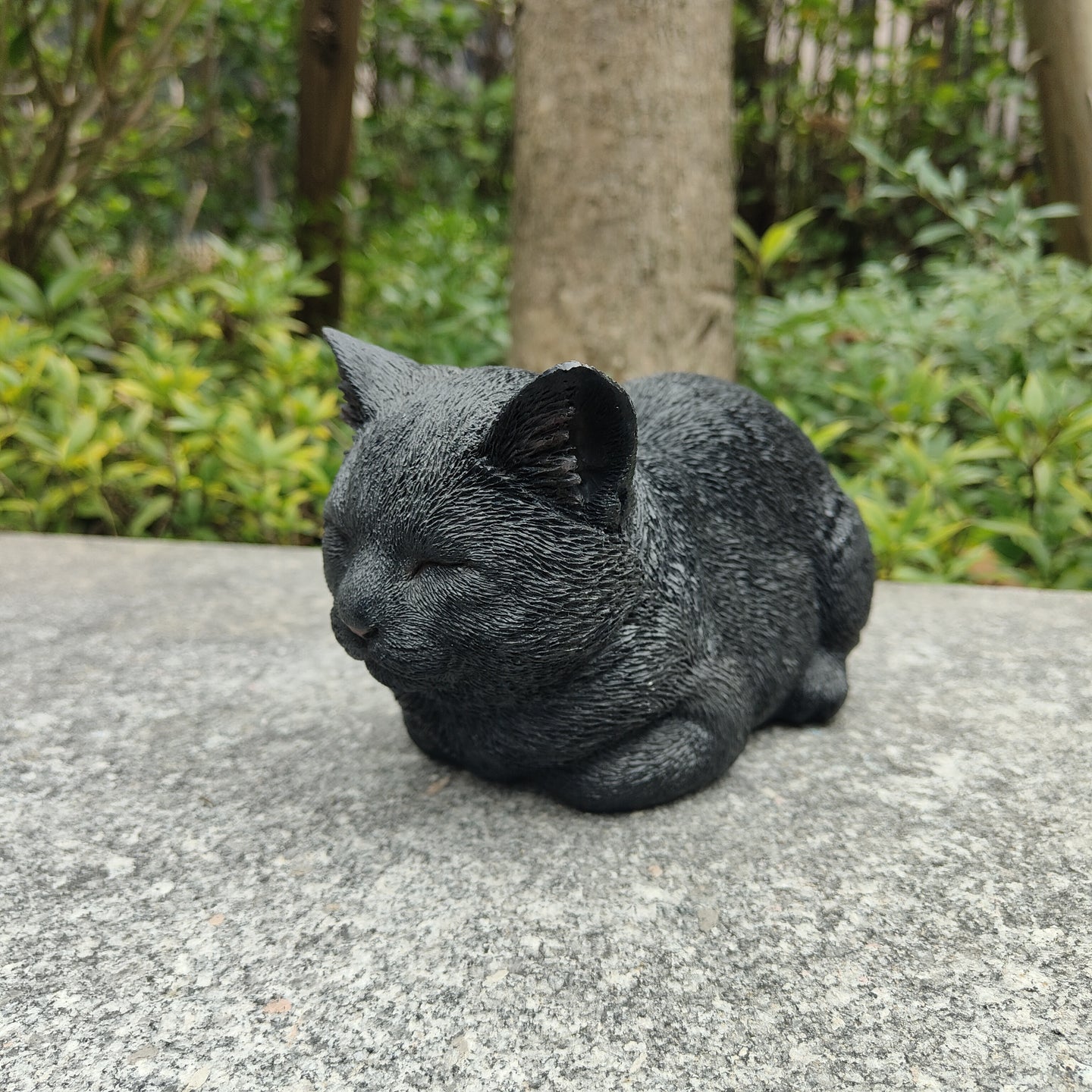 87729-E - Serenity Snooze: Chic Black Polyresin Napping Cat Figurine